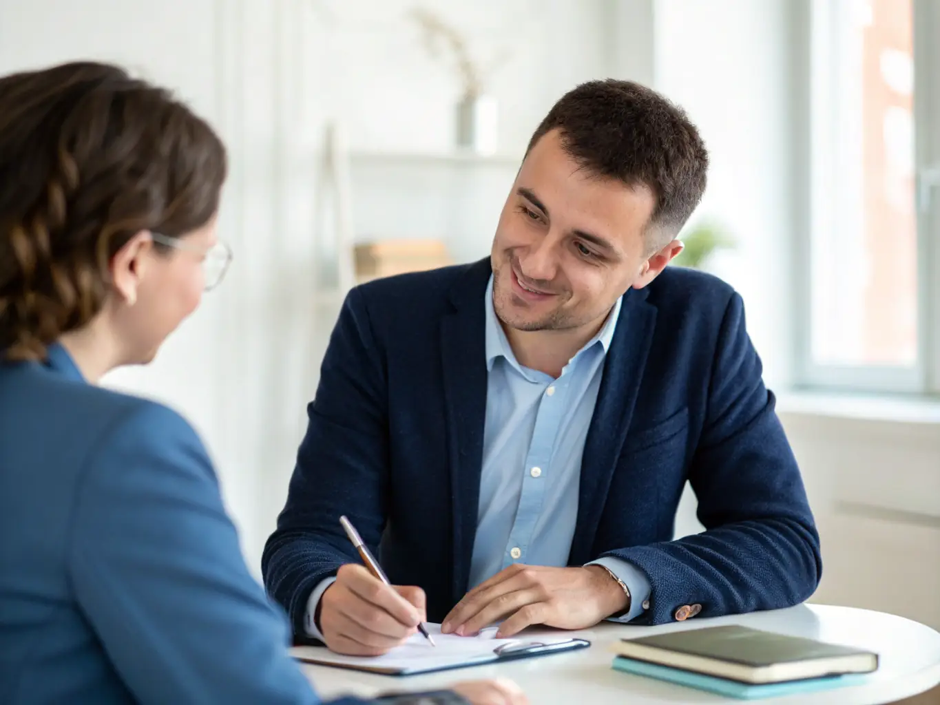 An image of a confident executive in a modern office, engaged in a coaching session with a coach, symbolizing leadership development.